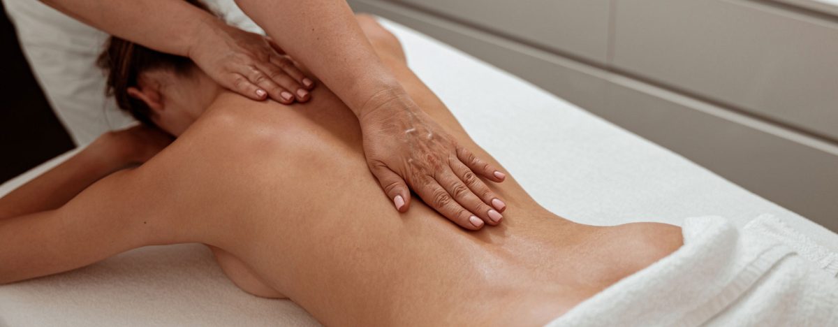 professional-masseuse-massaging-female-back-spa-salon